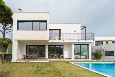 Casa de reciente construcción con piscina, jardín y vistas al mar.