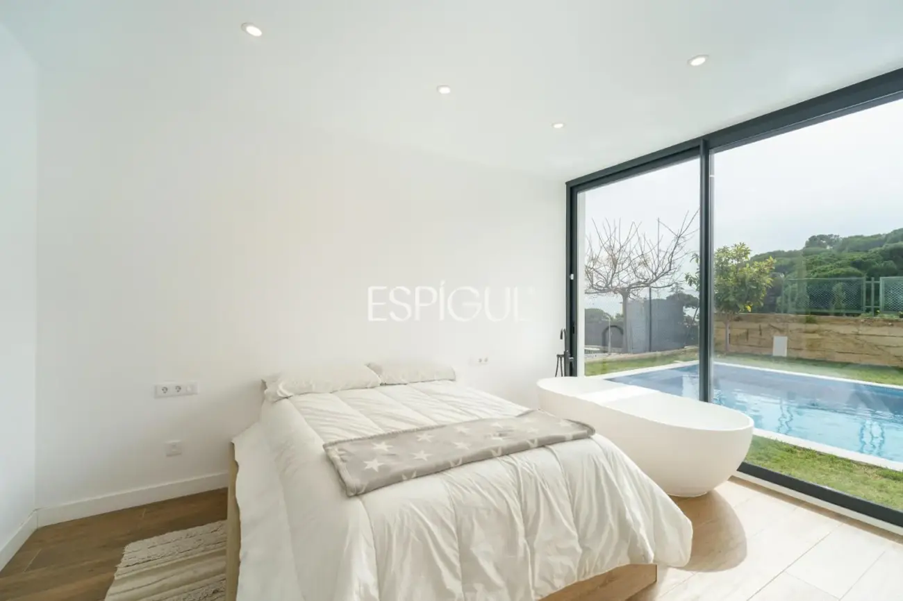 Casa de reciente construcción con piscina, jardín y vistas al mar.