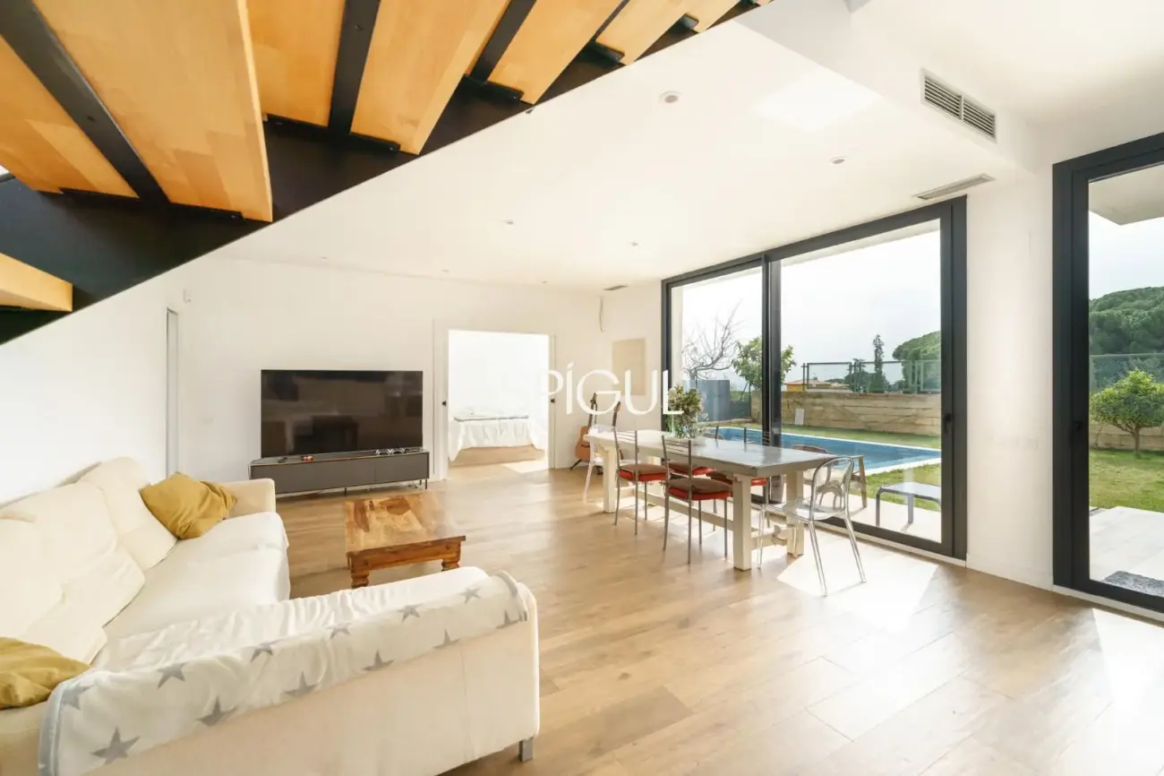 Casa de reciente construcción con piscina, jardín y vistas al mar.