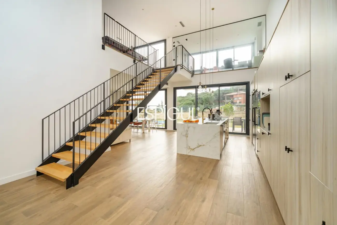 Casa de reciente construcción con piscina, jardín y vistas al mar.